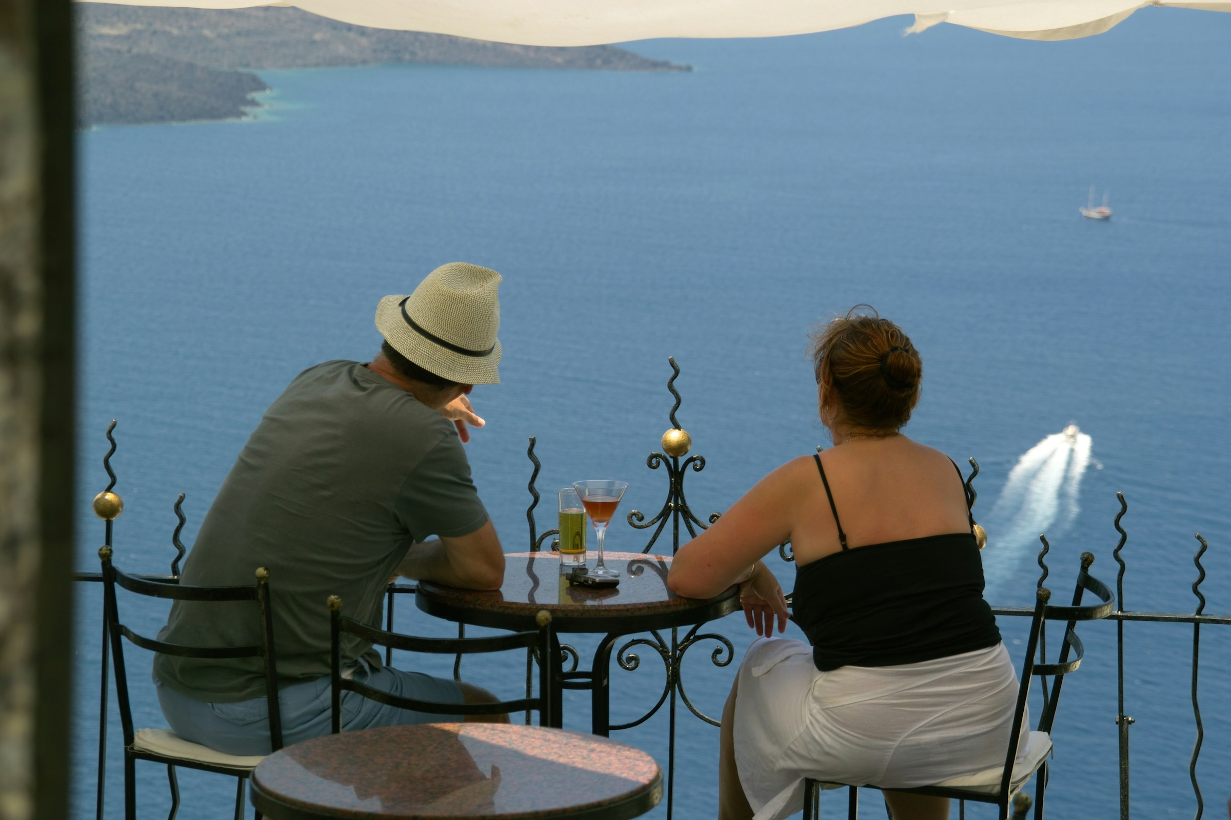 Couple on a terrace overlooking the Aegean sea